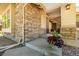 Inviting front porch showcasing stone accents and a glimpse into the home's entrance at 27565 E Nova Pl, Aurora, CO 80016