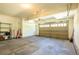 Spacious garage with an automatic door and plenty of space for parking and storage with shelving and equipment at 27565 E Nova Pl, Aurora, CO 80016