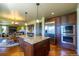 Open kitchen and dining area with stainless steel appliances and granite island at 27565 E Nova Pl, Aurora, CO 80016
