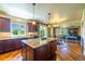 Kitchen and living area featuring a large center island and stainless steel appliances at 27565 E Nova Pl, Aurora, CO 80016