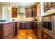 Gourmet kitchen with custom wood cabinetry, stainless steel appliances, and granite countertops at 27565 E Nova Pl, Aurora, CO 80016