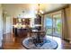 Open kitchen and dining area with access to the outdoor deck, hardwood floors throughout at 27565 E Nova Pl, Aurora, CO 80016
