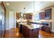 Bright kitchen featuring a center island with granite countertop and ample cabinet space at 27565 E Nova Pl, Aurora, CO 80016