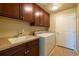 Functional laundry room with a sink, countertop space, ample cabinetry and a new washer and dryer at 27565 E Nova Pl, Aurora, CO 80016
