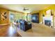 Bright living room boasting large windows, a cozy fireplace, and ample seating at 27565 E Nova Pl, Aurora, CO 80016