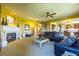 Large living room with fireplace, plush seating, and open layout at 27565 E Nova Pl, Aurora, CO 80016