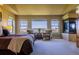 Well-lit main bedroom with large windows offering natural light and neighborhood views, carpet flooring, and ceiling fan at 27565 E Nova Pl, Aurora, CO 80016