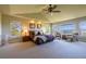 The main bedroom has large windows with neighborhood views, neutral carpet, and a ceiling fan at 27565 E Nova Pl, Aurora, CO 80016