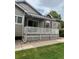 Charming back porch features a white lattice railing, and retractable awning creating a cozy outdoor retreat at 9025 W 79Th Way # D, Arvada, CO 80005