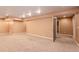 A finished basement featuring neutral carpeting and paint, with recessed lighting and ample space at 9025 W 79Th Way # D, Arvada, CO 80005
