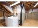 Unfinished basement laundry area with washer, dryer, and exposed utilities at 9025 W 79Th Way # D, Arvada, CO 80005