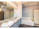 Bathroom featuring double sinks, a soaking tub, and updated fixtures at 9025 W 79Th Way # D, Arvada, CO 80005