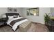 Relaxing bedroom showcases a bay window, tufted ottoman, and a stylish upholstered bed at 9025 W 79Th Way # D, Arvada, CO 80005
