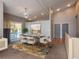 Bright dining area with modern chandelier, sliding door to the exterior, and a stylish rug at 9025 W 79Th Way # D, Arvada, CO 80005