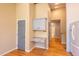 Hallway with built-in desk, grey cabinets, and wood flooring, providing style and function at 9025 W 79Th Way # D, Arvada, CO 80005