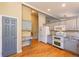 Kitchen with built in desk and grey cabinets plus stainless appliances and hardwood flooring at 9025 W 79Th Way # D, Arvada, CO 80005