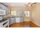 Bright kitchen with gray cabinetry, granite countertops, and wood flooring at 9025 W 79Th Way # D, Arvada, CO 80005