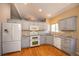 Well-lit kitchen featuring grey cabinets, granite countertops, and stainless steel appliances at 9025 W 79Th Way # D, Arvada, CO 80005