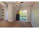 A living area with a sliding glass door providing access to a balcony and an ornamental fan at 9025 W 79Th Way # D, Arvada, CO 80005