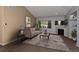 Comfortable living room featuring a cozy fireplace, large windows, and stylish decor at 9025 W 79Th Way # D, Arvada, CO 80005