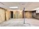 Spacious unfinished basement with paneled walls offering potential for customization at 12434 E Alaska Ave, Aurora, CO 80012
