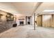 Basement with fireplace, brick wall, wood paneling at 12434 E Alaska Ave, Aurora, CO 80012