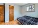 Cozy bedroom with hardwood floors, a window, and a closet for storage at 12434 E Alaska Ave, Aurora, CO 80012