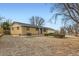 Charming brick home with a bench outside, set against a clear blue sky at 12434 E Alaska Ave, Aurora, CO 80012