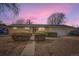 Charming single-story brick home featuring mature landscaping and an attached garage at 12434 E Alaska Ave, Aurora, CO 80012