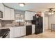 Bright kitchen featuring white cabinets, granite countertops, and stainless steel appliances at 12434 E Alaska Ave, Aurora, CO 80012