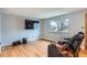 Cozy living room with hardwood floors, large window and modern entertainment system at 12434 E Alaska Ave, Aurora, CO 80012
