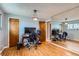 Functional home office space with hardwood floors, ample lighting, and a large mirror at 12434 E Alaska Ave, Aurora, CO 80012