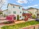 Spacious backyard with a deck, patio area, well-maintained lawn, and a colorful blooming tree adding natural beauty at 735 Chesapeake Ave, Monument, CO 80132