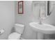 This bathroom features a toilet, sink, vanity, and wall art at 735 Chesapeake Ave, Monument, CO 80132