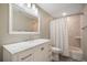 Bathroom features a white vanity with marble countertop, large mirror, and shower with curtain at 735 Chesapeake Ave, Monument, CO 80132