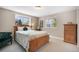 Bedroom with two windows, carpeted floors, and natural wood furniture at 735 Chesapeake Ave, Monument, CO 80132