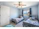 This bedroom has two beds, carpet, a ceiling fan, and a window at 735 Chesapeake Ave, Monument, CO 80132