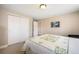 Cozy bedroom features a patterned quilt, white closet doors, and neutral-toned walls at 735 Chesapeake Ave, Monument, CO 80132