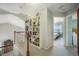Upstairs hallway featuring a bookcase, carpeted floors, and a view into a bedroom at 735 Chesapeake Ave, Monument, CO 80132