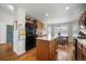 Kitchen features granite countertops, black fridge and oven, an island, wood cabinets, and hardwood floors at 735 Chesapeake Ave, Monument, CO 80132