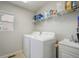 This laundry room has a washer, dryer, and plenty of shelving for storage at 735 Chesapeake Ave, Monument, CO 80132