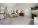 Open-concept living room featuring fireplace, a vaulted ceiling, lots of natural light, and an adjoining dining area at 735 Chesapeake Ave, Monument, CO 80132
