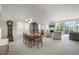 Bright open-concept living room with vaulted ceiling, fireplace, large windows, and an adjoining dining area at 735 Chesapeake Ave, Monument, CO 80132