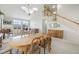Bright living room featuring mountain views, a fireplace, and an open floor plan to a dining room and staircase at 735 Chesapeake Ave, Monument, CO 80132