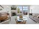 Inviting living room with a fireplace, large windows offering scenic views, and comfortable seating arrangement at 735 Chesapeake Ave, Monument, CO 80132