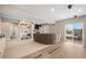 Spacious living room with a fireplace, walkout access, and built-in shelving at 735 Chesapeake Ave, Monument, CO 80132