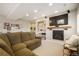 Cozy living room with fireplace, built-in shelving, and neutral decor at 735 Chesapeake Ave, Monument, CO 80132