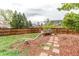 Fenced backyard featuring mature trees, grass, and a decorative water trough feature at 10109 W Fremont Ave, Littleton, CO 80127
