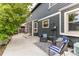 Relaxing backyard patio with comfortable seating, potted plants, and gray siding at 10109 W Fremont Ave, Littleton, CO 80127