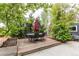 Backyard deck area with mature trees, a dining table and plenty of shade at 10109 W Fremont Ave, Littleton, CO 80127